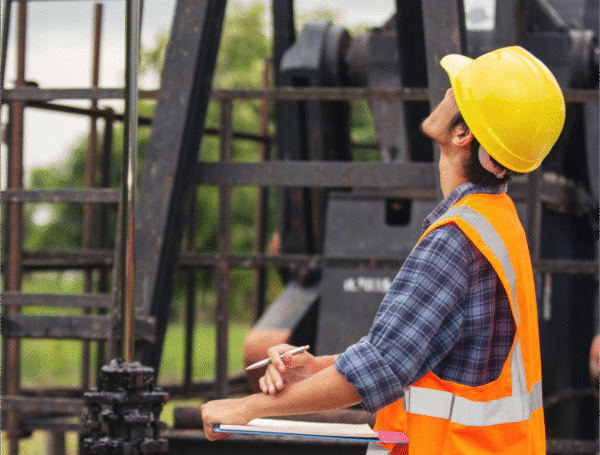 Engineers installing high-voltage electrical control panel in an industrial plant in Saudi Arabia.